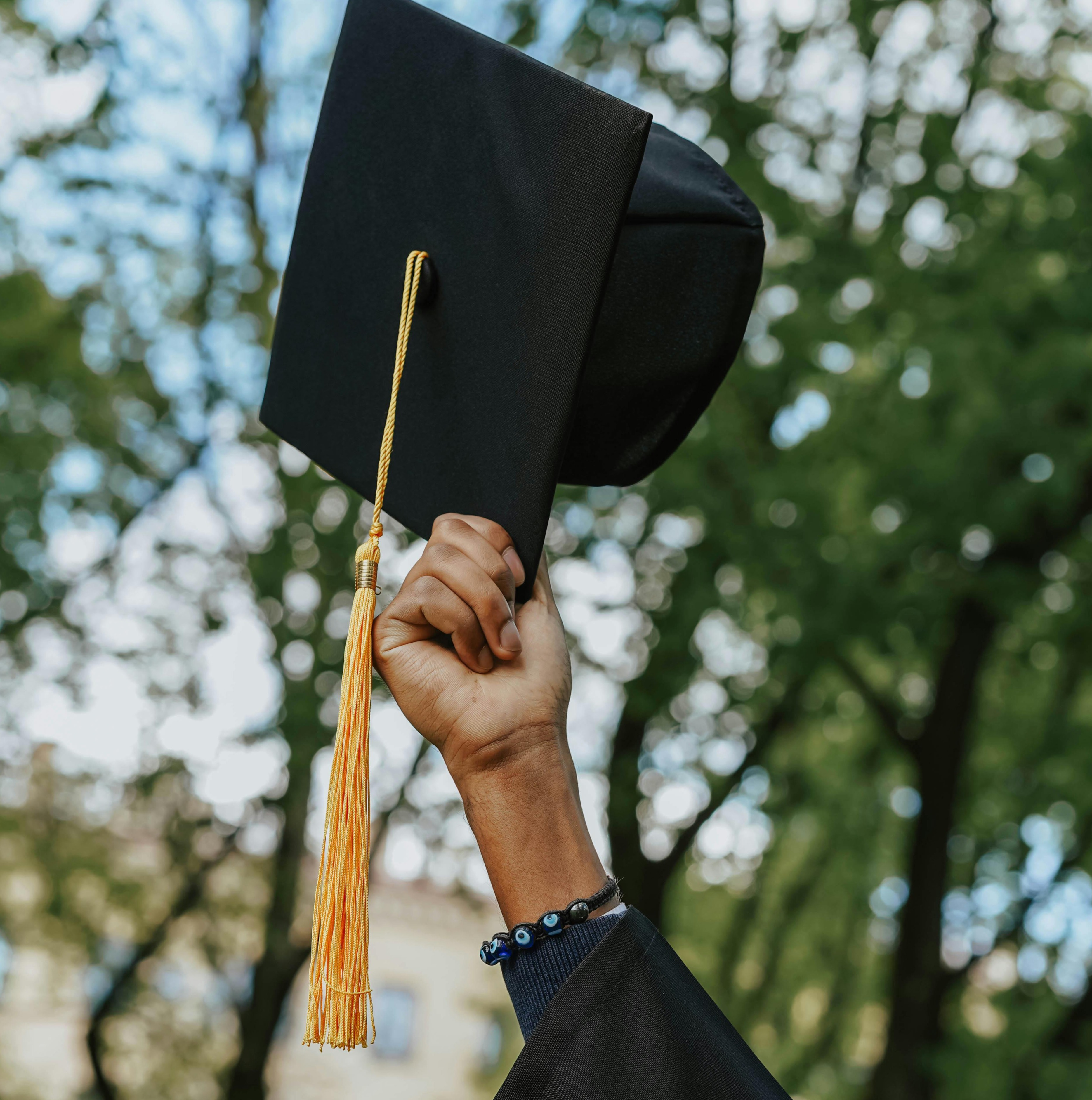 Graduation cap held by a future college student, symbolizing achievement and success supported by scholarships.